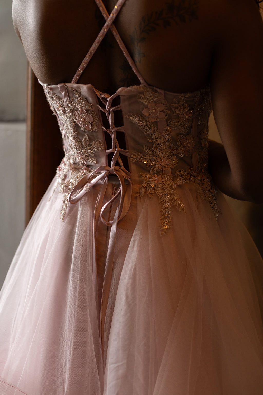 Soft pink layered dress with floral beaded top and lace up back.